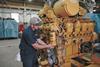 Caterpillar technician servicing a Cat 3508 marine engine