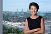 The photo shows Lynn Loo smiling for the camera in front of a port back drop