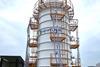 Workers in white hard hats in front of an HD KSOE LH2 vacuum tank