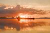 A ship silhouetted against a salmon pink sunset