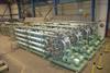 A large Hamworthy MBR system destined for a cruise ship, seen during factory inspection, showing the finished membrane skids in the foreground with the inter-stage filtration units behind