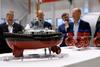 Miniature model of a Damen RSD Tug 2513 with five men in the background