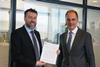Morten Jensen, sales & marketing manager at Lloyd's Register (left) handing over the statement of fact to Ulrich Schittek, head of management services, after sales, at Maersk Tankers (right) Photo: Maersk Tankers