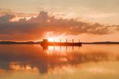 A ship silhouetted against a salmon pink sunset