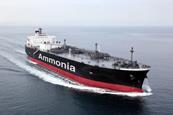 A black and red ship on the sea with the word "Ammonia" painted on the side.