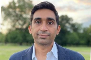 A head and shoulders shot of Neel Shah in a blue suit