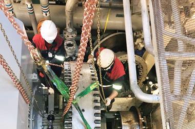Burckhardt Compression experts working on the compressor skid in the confines of the compressor machinery room (CMR)