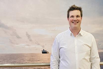 The image shows Martin White, CEO of Stream Marine Training in front of a shipping background