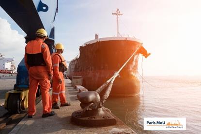 Engineers standing on a dock with a ship alongside