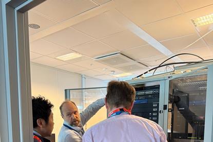 Three men looking at some equipment