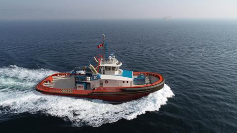 Image of a tug flying a Canadian flag