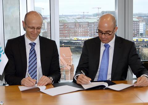 DNV GL's Büssow (left) and Rohaan of VPS sign an agreement of cooperation for the new fuel analytics tool