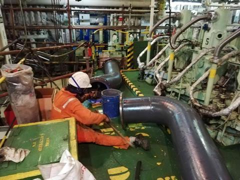 Crew members performing pipe coating. (Image: Mouawad Consulting)