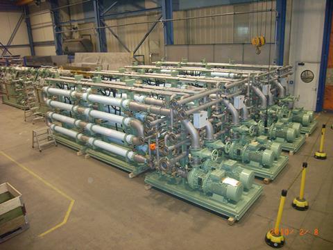 A large Hamworthy MBR system destined for a cruise ship, seen during factory inspection, showing the finished membrane skids in the foreground with the inter-stage filtration units behind