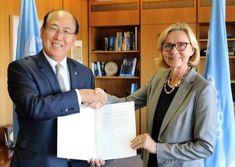 Päivi Luostarinen, permanent representative of Finland to IMO, hands the country's instrument of acceptance to Kitack Lim, secretary general, IMO